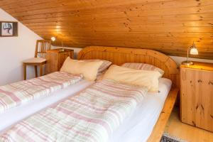 two beds in a room with wooden walls at Ferienwohnung Schlegel in Singen +21 photos