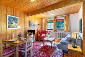 a living room with a couch and a table at Landhaus Graf in Kniebis