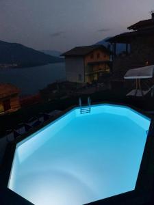 a swimming pool lit up in blue at night at Villa Wetzel Domaso in Montemezzo