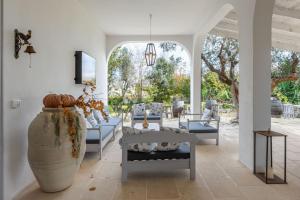 a living room with couches and a large vase at L'aia di San Giorgio in Ortelle