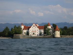 a large white building on a island in the water at Damkröger 2 Inselwohnung - Seeblick in Lindau