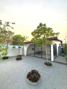 two trees in a courtyard in front of a building at De Paris Homestay in Cửa Lô