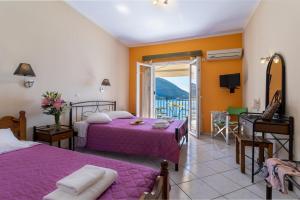 a bedroom with two beds and a balcony at Apostolos Apartment 3 in Póndi