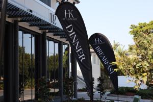 a sign for a hotel in front of a building at Hotel Kingsley in Brisbane
