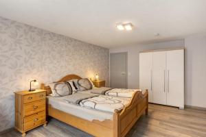 a bedroom with a large bed and a white cabinet at Ferienwohnung Christel in Schmallenberg