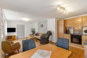 a kitchen and living room with a table and chairs at Ferienwohnung Christel in Schmallenberg