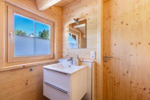 a bathroom with a sink and a mirror at Chalets Jettweiler in Stockach +59 photos