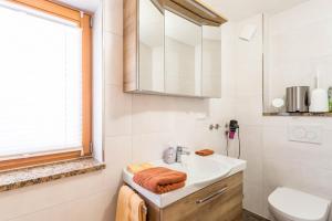 a bathroom with a sink and a toilet at Ferienwohnung Bernstein in Mittenwald