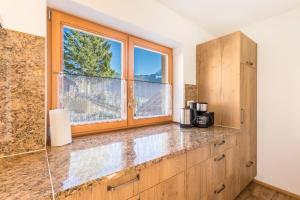 a kitchen with a counter and a window at Ferienwohnung Bernstein in Mittenwald