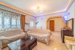 a living room with a couch and a table at Panorama House Petritis in Petrití