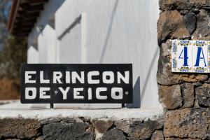 a sign on the side of a stone building at El Rincón de Yeico in Isora