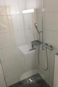 a shower with a shower head in a bathroom at Apartment Chalet Steinbock by Interhome in Lenk