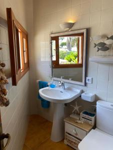 a bathroom with a sink and a mirror at Casa Vora Mar in Felanitx +24 photos