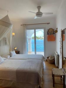 a bedroom with a bed and a view of the ocean at Casa Vora Mar in Felanitx
