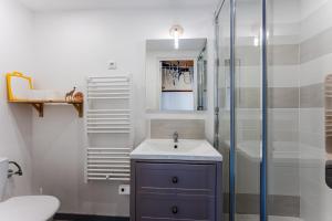 a bathroom with a sink and a glass shower at Loft familial Arcachon in Arcachon +14 photos