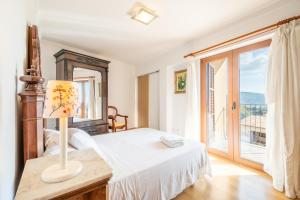 a bedroom with a bed and a large window at Can Vidal in Campanet