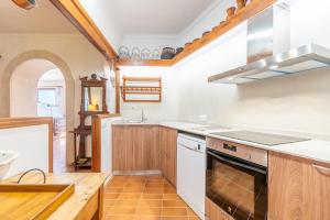 a kitchen with a sink and a stove at Can Vidal in Campanet