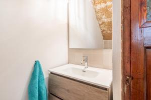 a bathroom with a sink and a green towel at Can Vidal in Campanet +24 photos