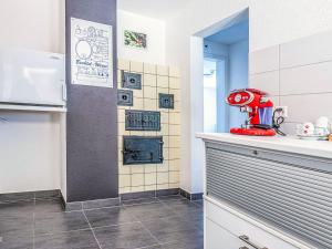 a kitchen with a red appliance on a counter at Apartment Hirschen Erlinsbach by Interhome in Erlinsbach +7 photos