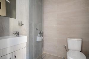 a bathroom with a toilet and a sink at Iguana studio 9 in Preveza +16 photos