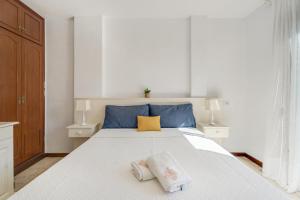 a bedroom with a white bed with two pillows on it at Atico cardon beach in Costa Adeje
