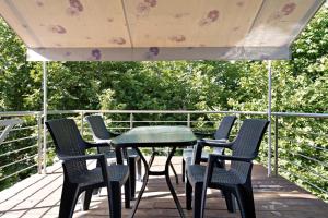 a group of chairs and a table on a deck at Iguana studio 9 in Preveza