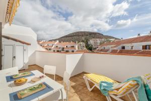 a balcony with a table and chairs on a building at Atico cardon beach in Costa Adeje