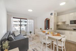 a kitchen and living room with a couch and a table at Atico cardon beach in Costa Adeje