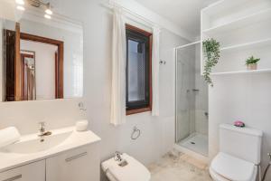 a bathroom with a sink and a toilet and a shower at Atico cardon beach in Costa Adeje +18 photos