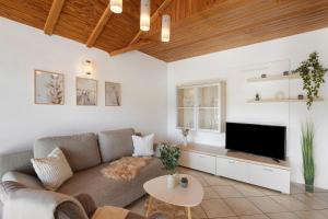 a living room with a couch and a tv at Rinderle in Stockach