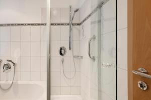a bathroom with a shower and a sink at Rinderle in Stockach +13 photos