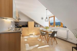 a kitchen with a table and chairs and a sink at Rinderle in Stockach