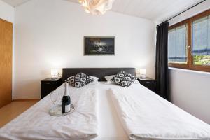 a bedroom with a bed with white sheets and pillows at Rinderle in Stockach