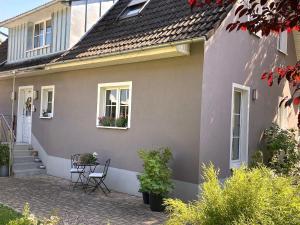 a house with chairs and a table in front of it at Haus Silberberg in Haslach im Kinzigtal
