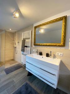a bathroom with a white sink and a mirror at Haus Silberberg in Haslach im Kinzigtal +17 photos