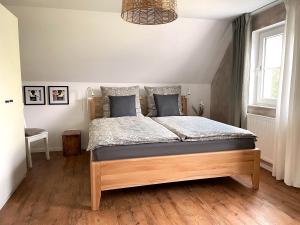 a bedroom with a large bed with blue pillows at Haus Silberberg in Haslach im Kinzigtal