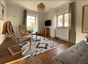 a living room with a couch and a chair at Haus Silberberg in Haslach im Kinzigtal