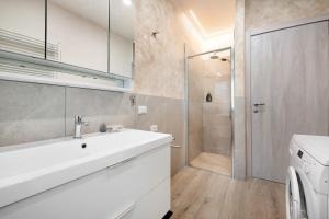 a bathroom with a white sink and a shower at Casa Tovini in Pisogne +29 photos
