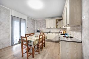 a kitchen with a table and chairs in a room at Casa Tovini in Pisogne