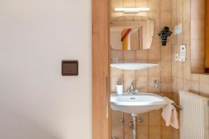 a bathroom with a sink and a mirror at Veltierhof Villnöß in Funes +90 photos