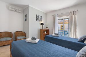a bedroom with two beds and a window with a view at Villa Constança in Manta Rota +20 photos