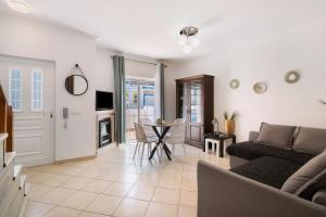 a living room with a couch and a table at Villa Constança in Manta Rota
