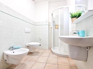 a bathroom with a sink and a toilet at Appartamenti Le Querce App. Melograno in Capoliveri