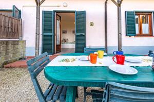 a blue table with plates and cups on it at Appartamenti Le Querce App. Melograno in Capoliveri
