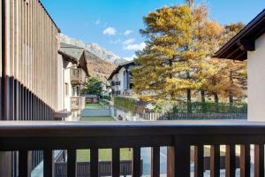 a view from the balcony of a town with mountains at Olympic Chalet 11 in Bormio