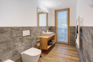 a bathroom with a toilet and a sink at Olympic Chalet 11 in Bormio +17 photos