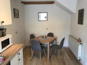 a small dining room with a table and chairs at Ferienhaus Am Fulda Ufer in Rotenburg an der Fulda