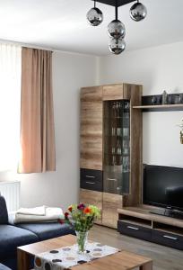 a living room with a couch and a coffee table at Ferienwohnung Zum Steiger in Bleicherode