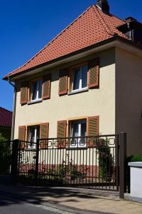 a house with a black fence in front of it at Ferienwohnung Zum Steiger in Bleicherode