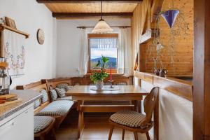 a kitchen with a table and chairs and a window at Ferienhaus Brigitte - Breitnau in Breitnau